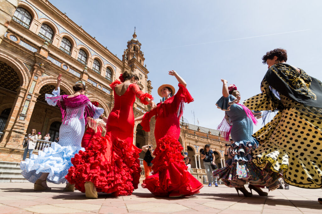 Young women dance flamenco on Plaza de Espana in Seville, Spain