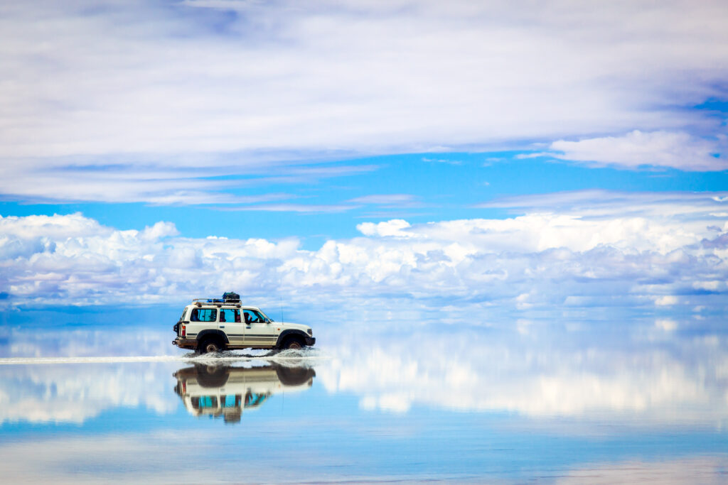 Sports Utility Vehicle driving in the Salar de Uyuni